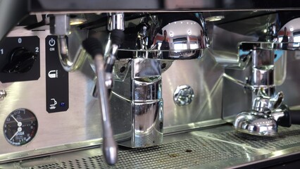 Professional espresso machine brewing shiny chrome plated group heads inside bustling Lombardy coffee bar