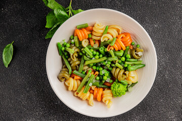 Trottole pasta vegetables green peas, green beans, kohlrabi cabbage, broccoli second course tasty snack fresh delicious gourmet food background on the table rustic food top view copy space