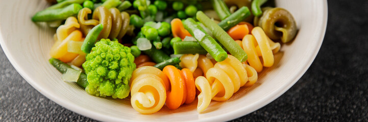 Trottole pasta vegetables green peas, green beans, kohlrabi cabbage, broccoli second course tasty snack fresh delicious gourmet food background on the table rustic food top view copy space