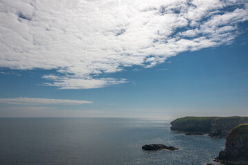 The Buchan coastline in the north-east of Scotland, with views of cliffs, the sea and  blue sky, taken from the Buchan Coastal Path.
