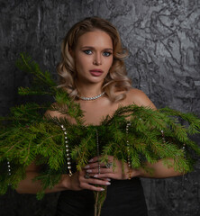 Elegant Woman Holding Greenery with Jewelry Accents, Showcasing Natural Beauty and Grace in a...