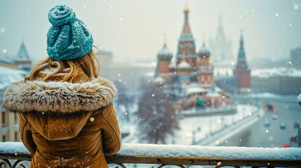 A documentary-style photo captures a peaceful moment of a person enjoying the snowy, cinematic view of Moscow's historic architecture on a cold day.