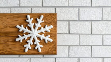 White Snowflake on Wooden Board Against Brick Wall