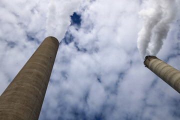 Amsterdam, The Netherlands - August 23rd, 2025 - Steam from the chimneys of waste incinerator AEB in Westpoort harbor