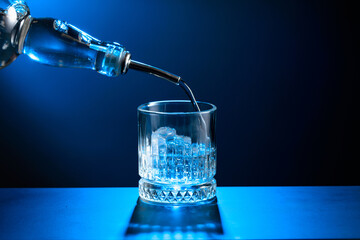 Vodka pours from bottle to glass with ice.