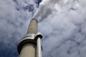 Amsterdam, The Netherlands - August 23rd, 2025 - Steam from the chimneys of waste incinerator AEB in Westpoort harbor