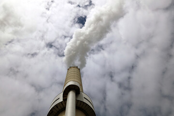 Amsterdam, The Netherlands - August 23rd, 2025 - Steam from the chimneys of waste incinerator AEB in Westpoort harbor