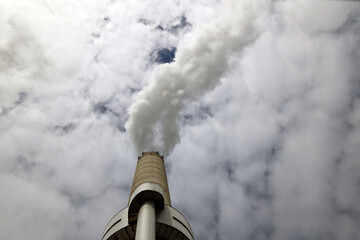 Amsterdam, The Netherlands - August 23rd, 2025 - Steam from the chimneys of waste incinerator AEB in Westpoort harbor
