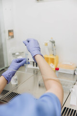 A young scientist working at a medical clinic conducts experiments in a laboratory.