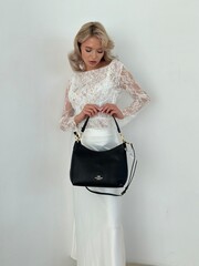 Elegant Fashion Showcase Featuring a Model in a Lace Top and Flowing White Skirt, Accessorized with...