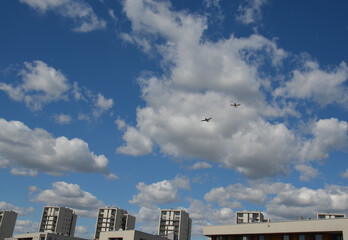 Air show during Polish Aviation Day in Krakow, Poland. Military and civil aircraft performing aerobatic maneuvers in the sky.