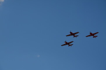 Air show during Polish Aviation Day in Krakow, Poland. Military and civil aircraft performing aerobatic maneuvers in the sky.