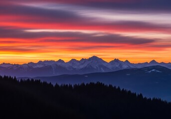 Vibrant sunset sky with colorful clouds over a silhouetted mountain range and forest