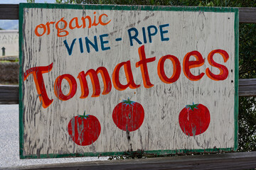 hand painted weathered sign for vine ripe farm tomatoes for sale 