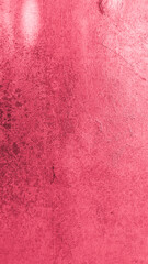 Close-up of a red painted wall with visible grunge stains and subtle scratches