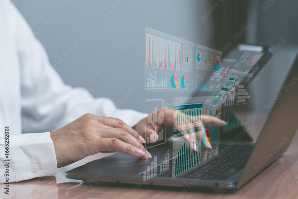 Poster hands typing on laptop with digital charts overlay, representing data analytics, business intelligen