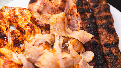 Delicious and healthy mixed grill platter featuring juicy chicken shish, tender lamb shish, and sliced chicken doner kebab. Served on a rustic wooden board. Perfect for food blogs, menus and more.