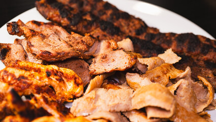 Delicious and healthy mixed grill platter featuring juicy chicken shish, tender lamb shish, and sliced chicken doner kebab. Served on a rustic wooden board. Perfect for food blogs, menus and more.