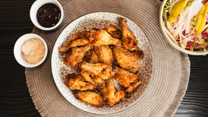 Golden-brown crispy fried chicken served with a fresh side salad bowl and creamy dipping sauce. Perfectly styled for food photography, highlighting texture and balance. Ideal for menus, blogs, and soc
