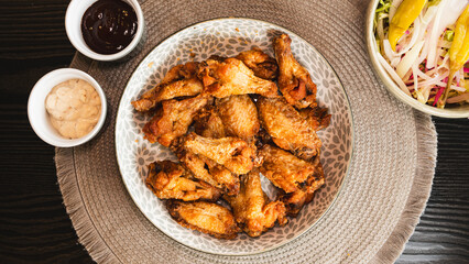 Golden-brown crispy fried chicken served with a fresh side salad bowl and creamy dipping sauce. Perfectly styled for food photography, highlighting texture and balance. Ideal for menus, blogs, and soc