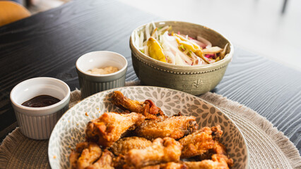 Golden-brown crispy fried chicken served with a fresh side salad bowl and creamy dipping sauce. Perfectly styled for food photography, highlighting texture and balance. Ideal for menus, blogs, and soc