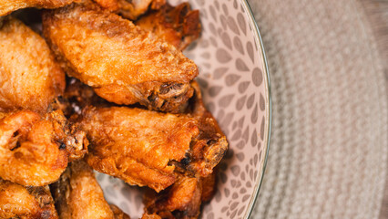 Close-up of golden-brown, crispy fried chicken served on a stylish plate. Highlights the perfect texture and seasoning. Ideal for food blogs, restaurant menus, and social media content promoting comfo