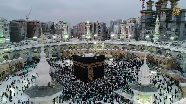 Aerial view of pilgrims circling the Kaaba during Hajj in Mecca, with modern buildings in the background (1)