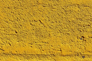 Close-up view of a textured, yellow surface.