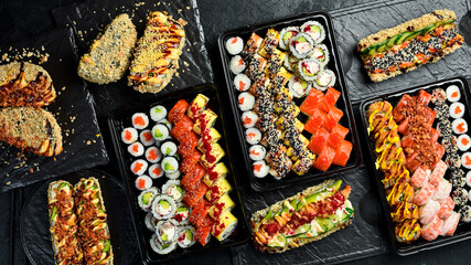 Set of sushi rolls and maki with fish, caviar, cheese and avocado. Close-up.