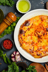 Traditional Georgian khachapuri mingrelian with cheese and caviar. Georgian cheese pie.