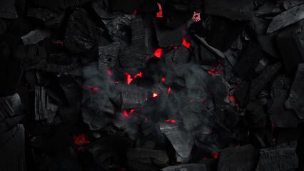 Black charcoal texture. Glowing hot charcoal for barbecue. Top view. Free space for text.