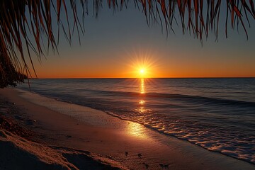 Beautiful beach sunset scenery with ocean waves and tropical palm fronds
