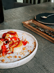 Delightful dessert with fresh fruit and caramel served on a rustic table