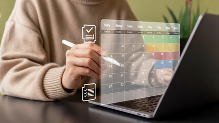 Person using a stylus on a transparent screen overlaying a laptop interacting with digital checklist and data visualization elements