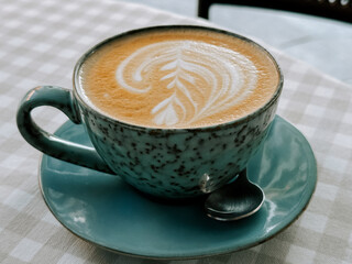 Perfectly crafted latte art in a serene cafe setting during morning hours