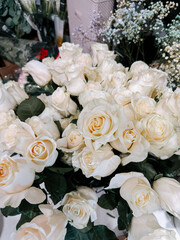 Beautiful white roses arranged elegantly for decoration and gifts in a floral shop setting