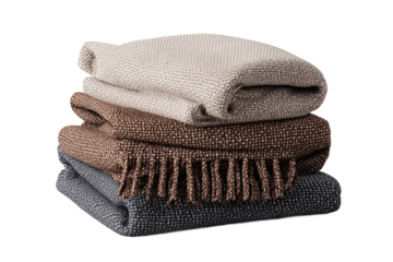 Stack of folded beige, brown, and black woven blankets, isolated on white transparent background