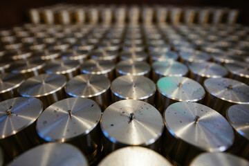 Cylindrical spare parts in rows, close up