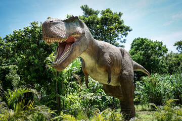 Pattaya​ Dinosaur Kingdom- 8th June 2025: A large dinosaur statue,life-size Tyrannosaurus Rex (T-Rex) model at Chonburi Province,Thailand.