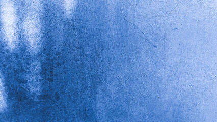 Close-up of a blue painted wall with visible grunge stains and subtle scratches