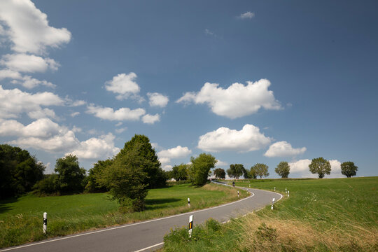 road in the countryside with clouds and big sky