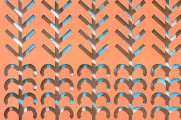 background composed of machine-cut decorative paper shapes with linear and curve cutouts arranged on blank paper