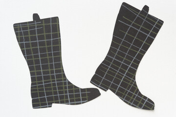 black paper boots with grid lines on a blank surface
