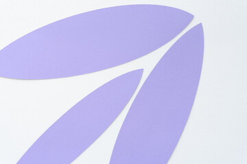 set of lancet shaped purple paper elements arranged on blank paper