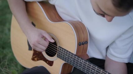 Young couple enjoying a peaceful day outdoors, bonding, talking, laughing, and playing guitar together in a natural, green park environment. - Powered by Adobe