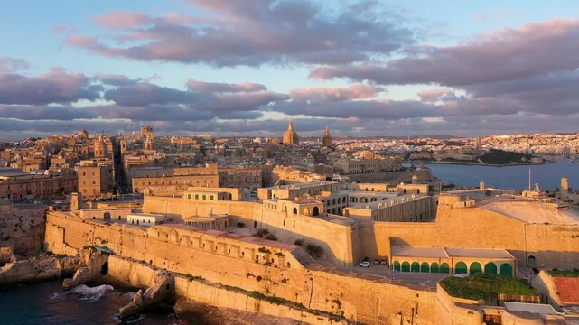 Aerial view of historic Valletta, Malta, during a stnning golden hour sunset.