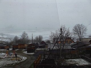 Wet spring snowfall in a village