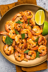 BBQ dinner with roast Shrimps Prawns in a plate. Gray background. Top view