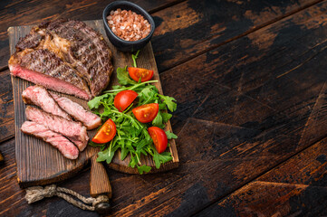 BBQ Grilled Rib eye steak on wooden board, roast  beef meat. wooden background. top view