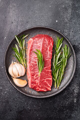 Australian Oyster Top blade steak, Fresh Beef shoulder meat on plate. black background. top view